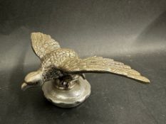 A Desmo eagle on ball car accessory mascot mounted on a radiator cap, approx. 2 3/4" high.