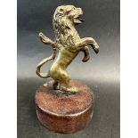 A brass car mascot in the form of a lion on hind legs, possibly for Argyle Cars, display base