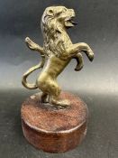 A brass car mascot in the form of a lion on hind legs, possibly for Argyle Cars, display base