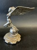 A car mascot in the form of a winged lady on top of a globe, possibly for the Triumph Gloria,