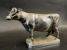 A car accessory mascot in the form of a cow, approx. 3 1/2" high.