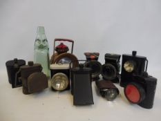 A selection of bicycle lamps and a Coventry Mineral Water Company glass cod bottle.
