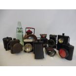 A selection of bicycle lamps and a Coventry Mineral Water Company glass cod bottle.