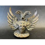 A rare car mascot in the form of a twin-headed griffin with cross on chest, approx. 4 1/2" tall.