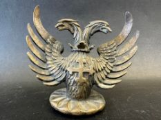 A rare car mascot in the form of a twin-headed griffin with cross on chest, approx. 4 1/2" tall.