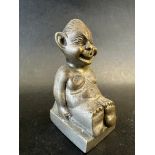 A car mascot in the form of a seated biliken, approx. 3" tall.