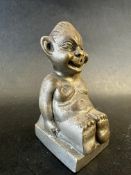 A car mascot in the form of a seated biliken, approx. 3" tall.