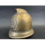 A brass policeman's helmet in the form of a money box, approx. 4" high.