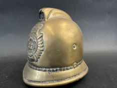 A brass policeman's helmet in the form of a money box, approx. 4" high.
