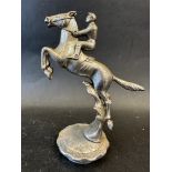 A car mascot depicting a jockey upon a horse on its hind legs, radiator cap mounted, approx. 6 1/