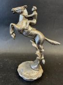 A car mascot depicting a jockey upon a horse on its hind legs, radiator cap mounted, approx. 6 1/