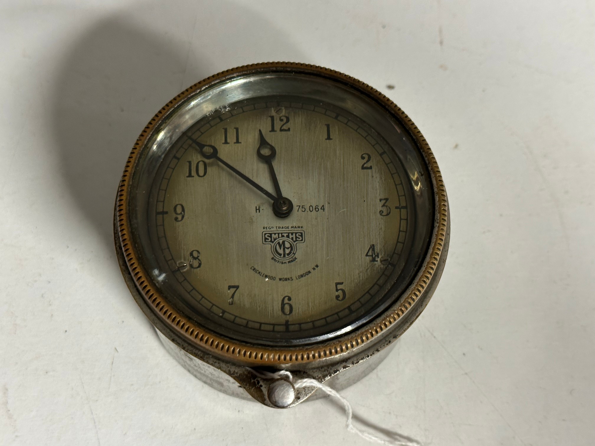 A Smiths silver faced eight day car clock.
