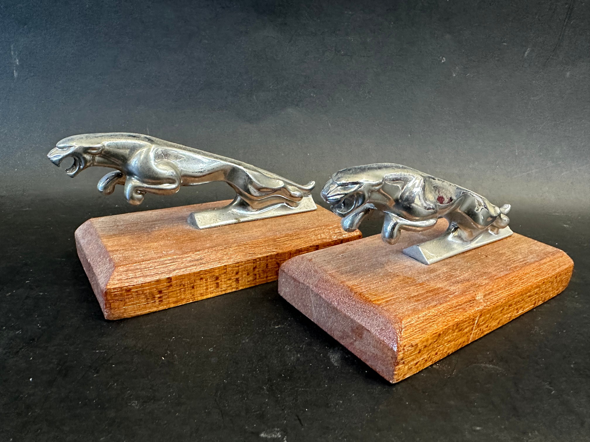 Two car mascots in the form of leaping jaguars, stamped to chest beneath, both wooden block