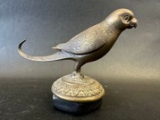 A brass car accessory mascot in the form of a bird with a long tail, radiator cap mounted, approx