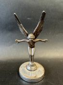 A car mascot in the form of a winged nude female, display base mounted, approx. 6 1/2" tall.