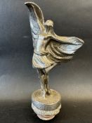 A car mascot in the form of a 1920s flapper girl, radiator cap mounted, approx. 8 1/2" tall overall.