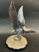 A car accessory mascot in the form of a bird of prey, by A.E. Lejeune, mounted on a radiator cap,