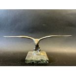 A car mascot depicting a bird in flight, marble base, stamped LL (Lejeune) to base approx. 3 1/2"