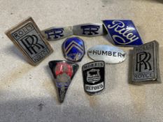 A selection of enamel radiator badges including a good Riley badge, plus an oval enamel plaque