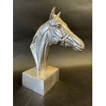 A polished aluminium horse's head desktop ornament, approx. 7 1/2" high.