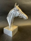 A polished aluminium horse's head desktop ornament, approx. 7 1/2" high.