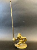 An unusual brass car mascot in the form of a troll running with a pole, approx. 10 3/4" tall.