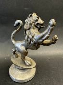 A circa 1930 Joseph Lucas Ltd. car mascot in the form of a lion rampant on oval base, display base
