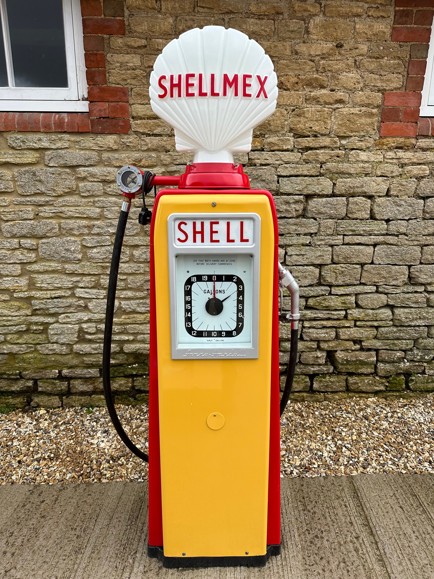 An Avery Hardoll electric petrol pump restored with reproduction glass petrol pump globe.