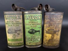 Three Luvax oval cans for shock absorber fluid.