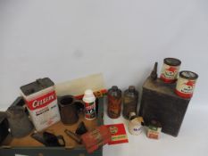 A box of assorted oil cans and measures including a Mobiloil quart can.