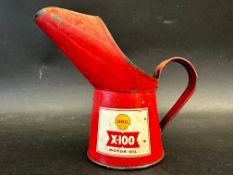 A Shell X-100 half pint measure in good condition.