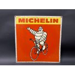 A Michelin pictorial tin advertising sign depicting Mr Bibendum sat upon a bicycle, 17 x 17 1/2".