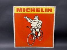 A Michelin pictorial tin advertising sign depicting Mr Bibendum sat upon a bicycle, 17 x 17 1/2".