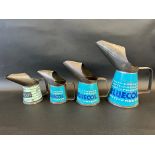A graduated set of three Bluecol Anti-Freeze measures, from quart to half pint, plus another