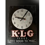 A Smiths Sectric tin fronted wall clock, with advertising for KLG Plugs, 10 1/2 x 14".