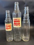A Shell X-100 Motor Oil quart bottle, a matching pint example and an Essolube pint bottle.
