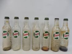Seven Castrol quart glass oil bottles.