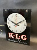 A Smiths Sectric wall hanging electric clock, advertising KLG Plugs, 10 1/2 x 14".