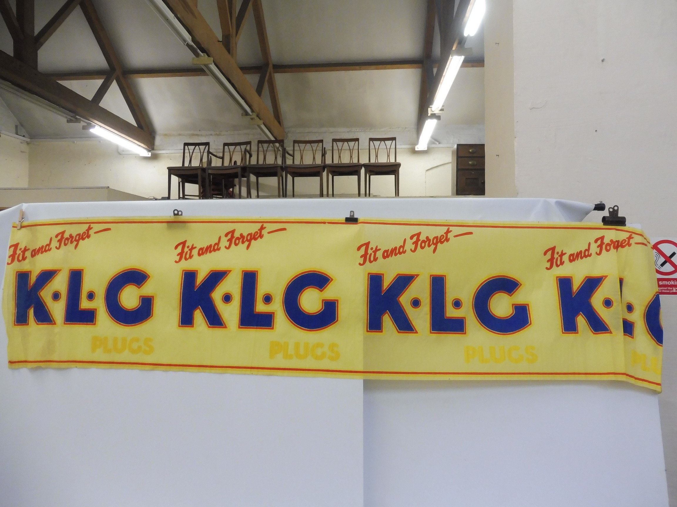A rare surviving KLG Batteries crepe paper advertisement.