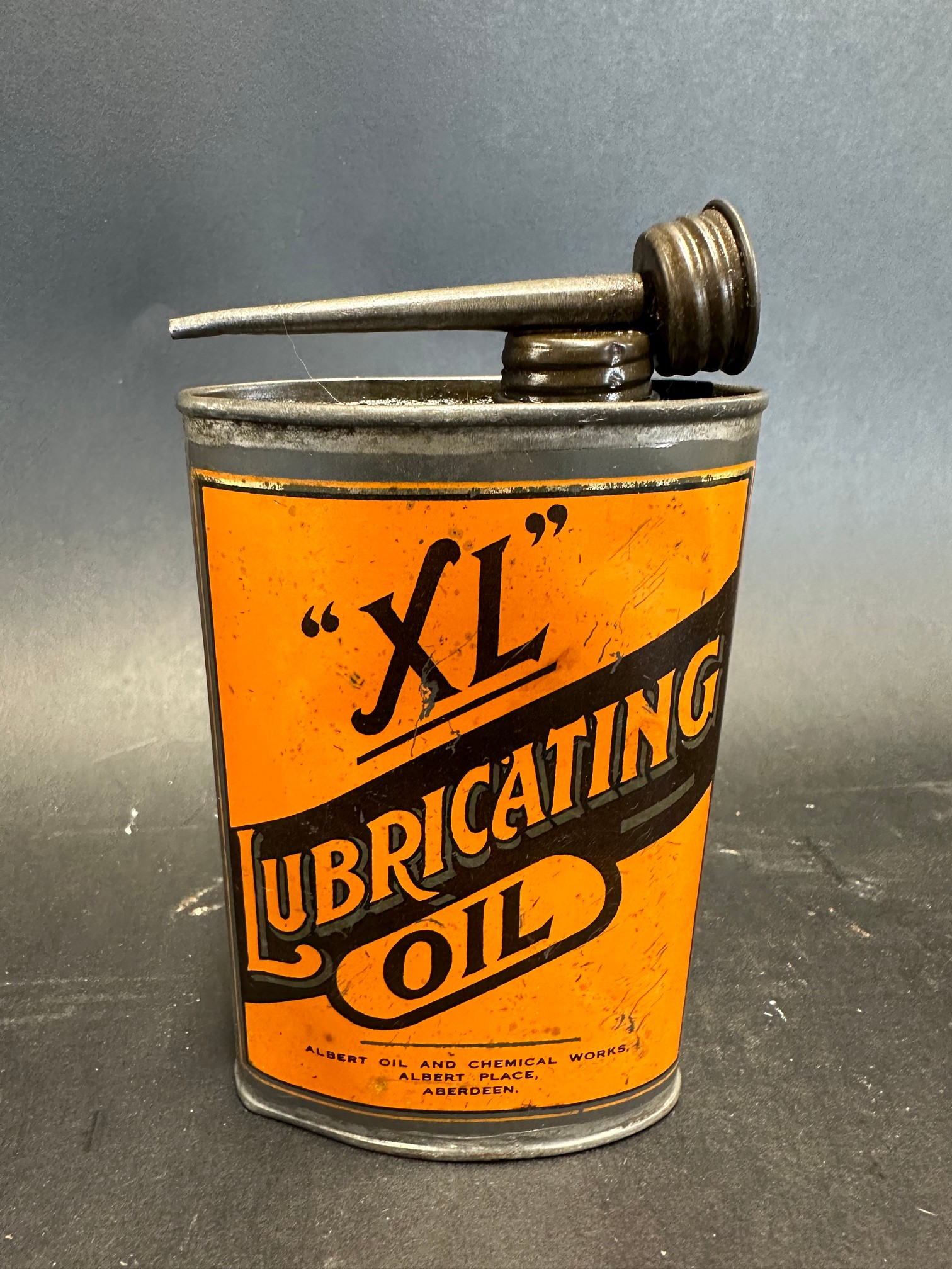 An XL Lubricating Oil oval tin.