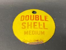 A small circular enamel brand tag for Double Shell Medium, 2 3/4" diameter.