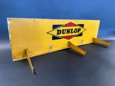 A Dunlop tin advertising sign/rack with three brackets, 27 1/2 x 7 1/2".