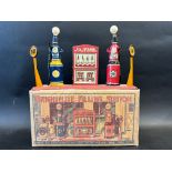 A rare boxed circa 1930s Marx Toys tinplate garage forecourt comprising two petrol pumps flanking
