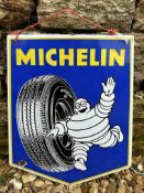 A small Michelin enamel sign with image of Mr Bibendum rolling a tyre, dated April 1965, 13 1/2 x