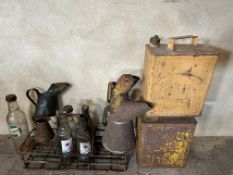 A selection of automobilia including oil bottles and petrol cans.