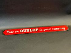 A 'Ride on Dunlop in Good Company' shelf strip.