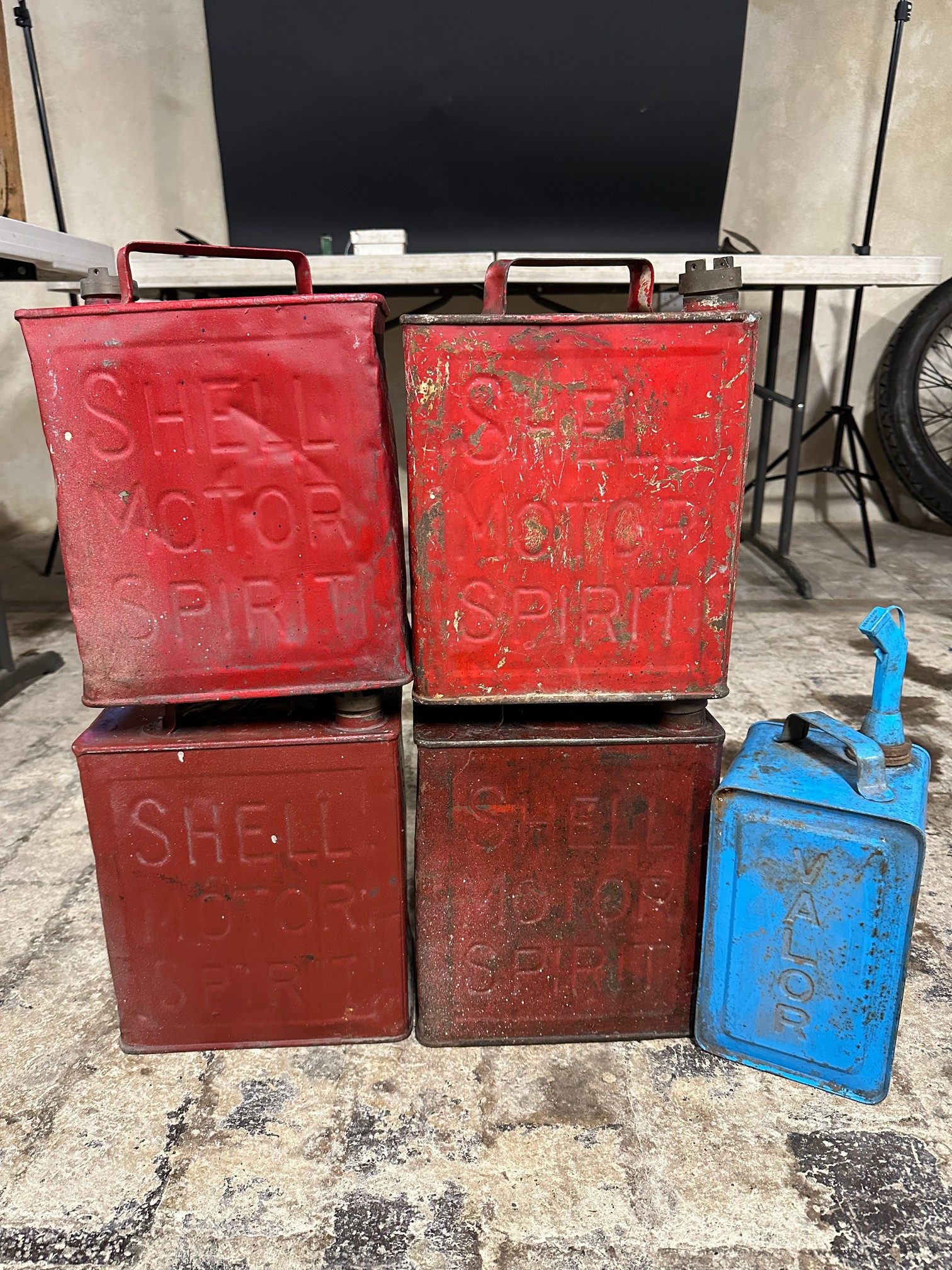 Four Shell two gallon petrol cans and a Valor paraffin can.