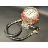 A Kismet wall mounted air pump gauge.