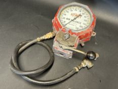 A Kismet wall mounted air pump gauge.