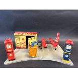 A Marx Toys tinplate filling station 'Sunny Side Service Station' complete with petrol pumps, car